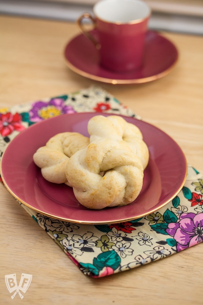 Cookies on a small plate with a cup of espresso in the background.