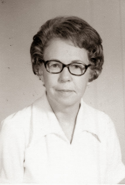 Black and white photo of woman in white uniform