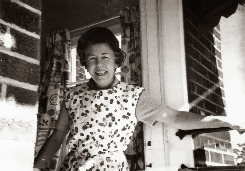 Black and white woman in full cherry print apron