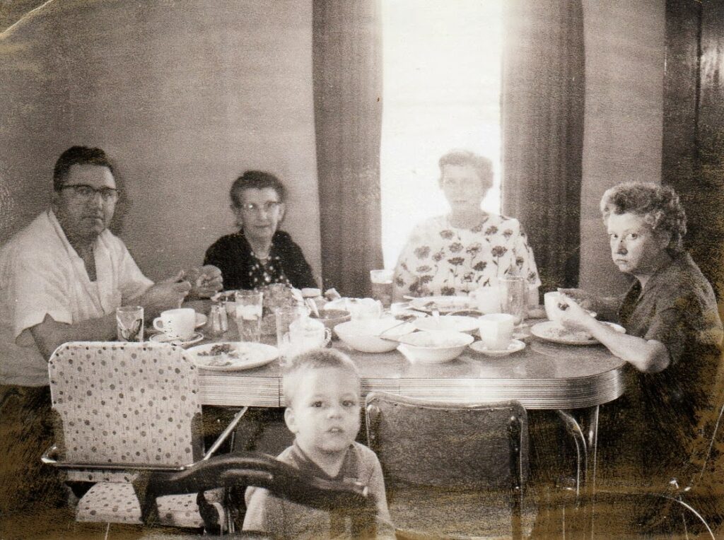 Black and white photo of family having a casual meal