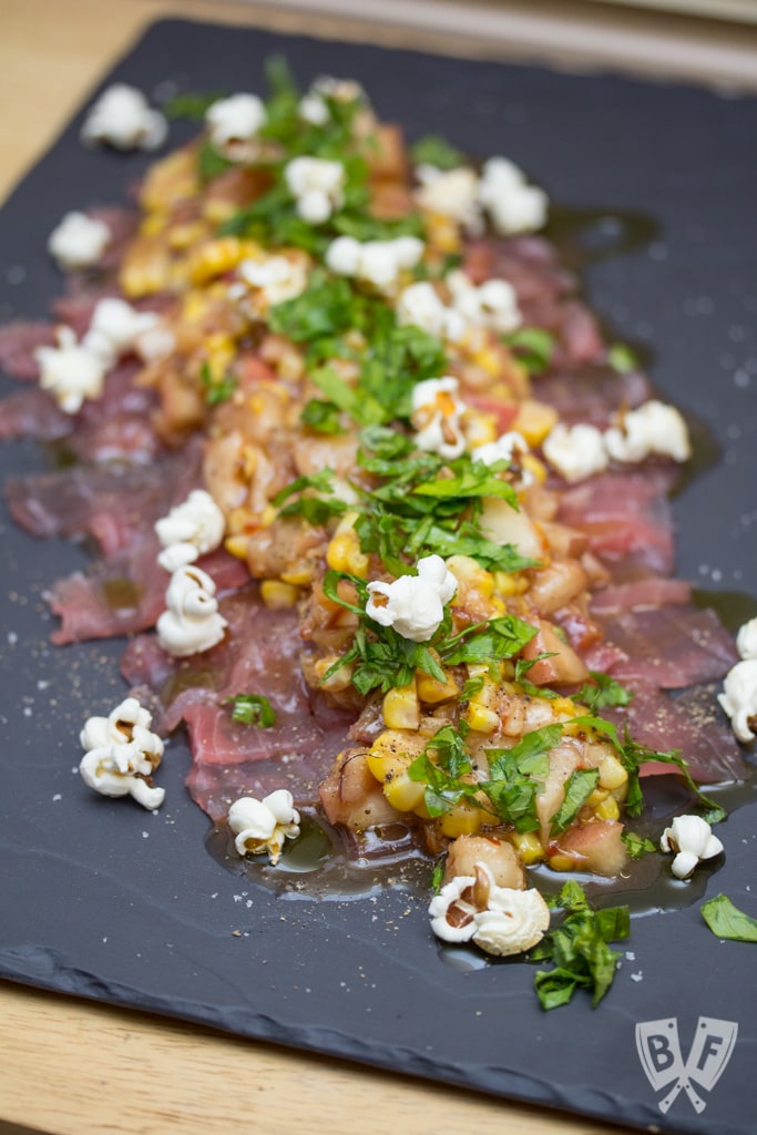 Raw Tuna with Pickled Peach & Corn Relish on a dark serving platter